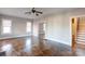 Bright living room featuring hardwood floors, neutral wall color, and an open doorway to the stairwell at 610 Hawthorne Ln, Charlotte, NC 28204