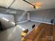 Garage with painted floors, gray walls, overhead lighting, a bar, and storage cabinet at 8603 Westhope St, Charlotte, NC 28216