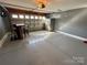 Garage area featuring painted floors, gray walls, overhead lighting, and a bar at 8603 Westhope St, Charlotte, NC 28216