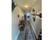 Inviting hallway with stylish decor, neutral paint, and tile floors leads into the home's interior at 8603 Westhope St, Charlotte, NC 28216