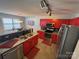 Modern kitchen with granite counters, stainless steel appliances, red cabinets, and stylish lighting fixtures at 8603 Westhope St, Charlotte, NC 28216