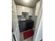 Well-lit laundry room featuring side-by-side washer and dryer, neutral wall paint, and ample white cabinetry at 8603 Westhope St, Charlotte, NC 28216