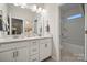 Bright bathroom featuring double vanity with white cabinetry, granite countertop and tub-shower combo at 8635 Miles Gap Rd, Indian Land, SC 29707