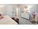 Bedroom featuring neutral walls, plush carpet, white dresser, and decorative butterfly accents at 8635 Miles Gap Rd, Indian Land, SC 29707