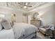 Comfortable main bedroom featuring decorative ceiling, neutral tones, dresser, and cozy seating area at 8635 Miles Gap Rd, Indian Land, SC 29707