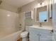 Bright bathroom featuring a tub and shower, modern vanity, and neutral color palette at 9607 Kestral Ridge Dr, Charlotte, NC 28269