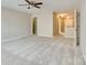 Spacious carpeted bedroom featuring a ceiling fan, neutral walls and entry to hallway at 9607 Kestral Ridge Dr, Charlotte, NC 28269