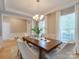 Dining room features wood floors, large windows with curtains, and a chandelier at 9607 Kestral Ridge Dr, Charlotte, NC 28269