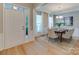 Dining room features wood floors, large windows with curtains, and a chandelier at 9607 Kestral Ridge Dr, Charlotte, NC 28269