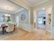 Open-concept dining area with wood floors, chandelier, and view to living room at 9607 Kestral Ridge Dr, Charlotte, NC 28269