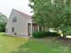 Well-maintained home with a brick-accented porch, mature trees, and a beautifully landscaped front yard at 9607 Kestral Ridge Dr, Charlotte, NC 28269
