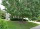 Charming home exterior with a well-maintained lawn and mature shade tree in a serene neighborhood at 9607 Kestral Ridge Dr, Charlotte, NC 28269