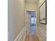 Hallway with wainscoting detail leading to a bedroom with ample natural light at 9607 Kestral Ridge Dr, Charlotte, NC 28269
