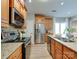 Kitchen with stainless steel appliances, wood cabinets, and granite countertops at 9607 Kestral Ridge Dr, Charlotte, NC 28269