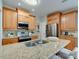 Updated kitchen boasts a granite island, stainless steel appliances, and wood cabinets at 9607 Kestral Ridge Dr, Charlotte, NC 28269