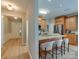 Bright kitchen featuring a breakfast bar, stainless steel appliances, and wood cabinetry at 9607 Kestral Ridge Dr, Charlotte, NC 28269