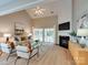 Bright living room featuring a fireplace, vaulted ceilings, and access to the outdoor patio at 9607 Kestral Ridge Dr, Charlotte, NC 28269