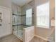 Shower featuring glass enclosure, tile surround, and a built-in seat at 9607 Kestral Ridge Dr, Charlotte, NC 28269