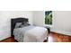 Bright bedroom with hardwood floors, soft bedding, and natural light from the window at 1001 Craven Ave, Kannapolis, NC 28083