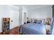Cozy bedroom featuring a wood floor, a bed with decorative pillows, and a bookcase at 1001 Craven Ave, Kannapolis, NC 28083