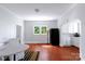 Inviting open-concept dining area that features hardwood floors, a table setup, and an archway leading to the kitchen at 1001 Craven Ave, Kannapolis, NC 28083