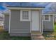 The exterior features gray siding, a white door, and green grass at 1001 Craven Ave, Kannapolis, NC 28083