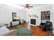 Bright living room featuring hardwood floors, a decorative fireplace, and ample natural light from a large window at 1001 Craven Ave, Kannapolis, NC 28083
