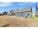 A view of the backyard showing a grey house at 1032 Barnette Farm Ln, Monroe, NC 28110