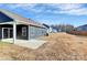 Spacious backyard with a covered patio, blue siding, and lots of room to entertain at 1032 Barnette Farm Ln, Monroe, NC 28110