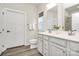 Contemporary bathroom features a double sink vanity, large mirror, and a separate toilet room at 1032 Barnette Farm Ln, Monroe, NC 28110