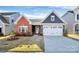 Charming single-story home with a brick accent, attached garage, and well-maintained lawn at 1032 Barnette Farm Ln, Monroe, NC 28110
