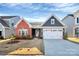 Charming single Gathering home with a two car garage, manicured lawn, and traditional architectural details at 1032 Barnette Farm Ln, Monroe, NC 28110