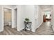 Hallway with hard surface floors, a decorative table, and doorways to rooms in the home at 1032 Barnette Farm Ln, Monroe, NC 28110