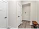 Neutral hallway featuring a modern style door, neutral paint, and wood look flooring at 1032 Barnette Farm Ln, Monroe, NC 28110