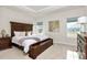 Serene main bedroom features a tray ceiling, carpeted floors, large windows, and stylish furnishings at 1032 Barnette Farm Ln, Monroe, NC 28110
