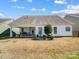 A view of a backyard with a covered patio and green space at 10547 Skipping Rock Nw Ln, Concord, NC 28027