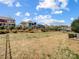 A view of a backyard with fencing, shrubs, and an undulated hill at 10547 Skipping Rock Nw Ln, Concord, NC 28027