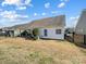 A view of a backyard with a covered patio and green space at 10547 Skipping Rock Nw Ln, Concord, NC 28027