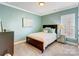 Cozy bedroom featuring a bed, bedside table and light-filled window for a relaxing ambiance at 10547 Skipping Rock Nw Ln, Concord, NC 28027
