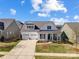 Charming two-story home featuring a three-car garage, covered porch and manicured lawn at 10547 Skipping Rock Nw Ln, Concord, NC 28027