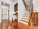 Inviting foyer featuring hardwood floors, a staircase, and a built-in desk area at 10547 Skipping Rock Nw Ln, Concord, NC 28027