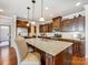 Spacious kitchen featuring a granite island, dark cabinetry, and modern stainless steel appliances at 10547 Skipping Rock Nw Ln, Concord, NC 28027