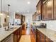 Modern kitchen features granite counters, stainless steel appliances, and dark wood cabinets for a luxurious feel at 10547 Skipping Rock Nw Ln, Concord, NC 28027
