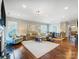 Open-concept living room featuring a large sectional sofa, hardwood floors, and recessed lighting throughout at 10547 Skipping Rock Nw Ln, Concord, NC 28027