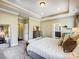 Lovely main bedroom with an ensuite bathroom, trey ceiling, and calming neutral color palette at 10547 Skipping Rock Nw Ln, Concord, NC 28027