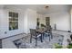 Cozy covered patio with a dining set, offering an ideal space for outdoor dining and relaxation at 10547 Skipping Rock Nw Ln, Concord, NC 28027