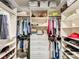 Spacious walk-in closet with custom shelving, drawer space, and ample hanging areas at 10547 Skipping Rock Nw Ln, Concord, NC 28027