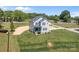 Aerial view of a two-story gray home with a new driveway and partially cleared lot at 106 Desert Sky Ct, Statesville, NC 28625