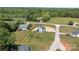 Aerial view of a gray two-story home with new driveway on a grassy, partially wooded lot at 106 Desert Sky Ct, Statesville, NC 28625