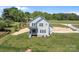 Aerial view of two-story home showing the backyard and surrounding green trees and lawn at 106 Desert Sky Ct, Statesville, NC 28625